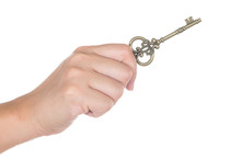 Woman's Hand Holding An Antique Key Isolated On White Background
