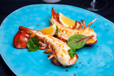 Fototapeta  - Lobster tail in maple-truffle sauce with lemon and basil