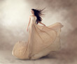 © Subbotina Anna - Fashion model in beautiful luxury beige flowing chiffon dress