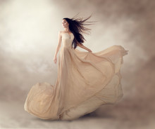 Fashion Model In Beautiful Luxury Beige Flowing Chiffon Dress
