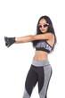 © Jade - Tan Skin Asian Fitness Girl in Gray Camouflage Sport Bra black spandex pants, stud gloves and sunglasses Exercise boxing warm up in white studio room,