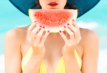 Summer Colors. Girl Holding Slice Of Watermelon On The Beach With Red Painted Nails. 
