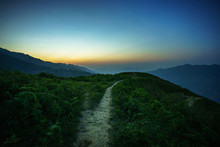 Road On Spine And The Top Of The Mountains Covered With Greenery With Gentle Valleys At Dawn