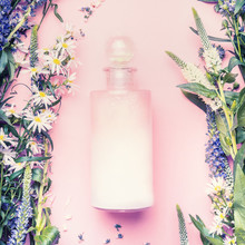 Natural Cosmetic Product Bottle Of Lotion,shampoo Or Moisturizer With Herbs And Flowers On Pink Background, Top View, Copy Space,  Square.  Beauty, Skin And Hair Care Concept
