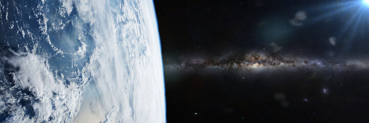 Wall Mural - planet Earth lit by the Sun and the Milky Way galaxy 