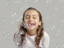 Girl Playing With Soap Bubbles