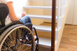 Person in a wheelchair in front of a stair