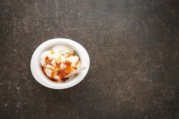 Sticker - Bowl with vanilla ice cream and caramel sauce on table