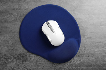 Wall Mural - Blank mat and wireless mouse on textured background