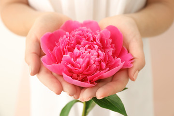 Poster - Young woman holding beautiful peony flower, closeup