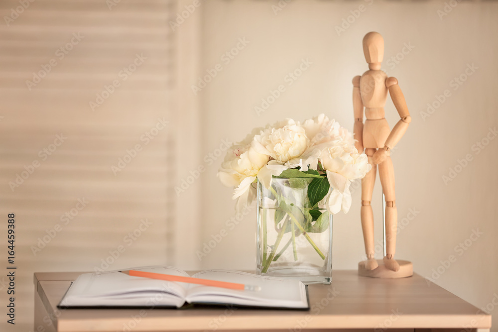 Composition with beautiful peonies in vase on table