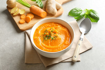 Wall Mural - Delicious carrot soup on gray table