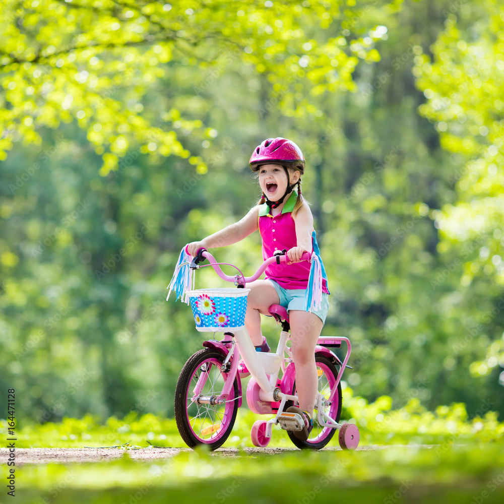 Child riding bike. Kid on bicycle. Stock Photo | Adobe Stock