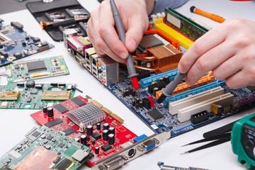 Poster - Engineer checking motherboard with multimeter