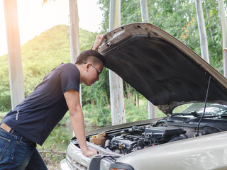 stressed young man opened the hood Broken car