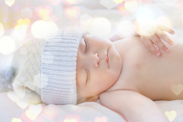 Wall Mural - Lovely sleeping baby and blurred lights, closeup