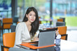 © Suntipong - Young pretty business woman with laptop in the office, smiling pretty young business woman in glasses sitting on workplace. Selective focus