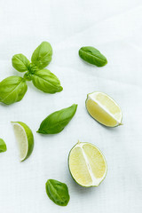 Wall Mural - Fresh basil and lime on white background