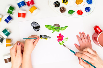 Wall Mural - Child's hands painting a flower