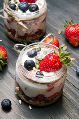 Wall Mural - delicious dessert - yogurt with strawberries and blueberries