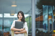 © Suntipong - Young pretty business woman with laptop in the office, smiling pretty young business woman in glasses sitting on workplace. Selective focus