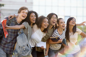 Canvas Print - Multiethnic group of young happy students standing outdoors