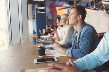 Aufkleber - Happy youthful guy and girls communicating at work in office