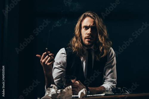 Bearded Handsome Long Haired Man In Formal Wear Smoking Cigar