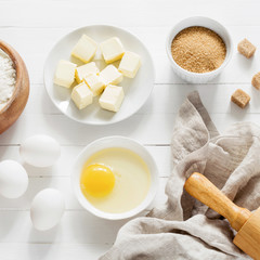 Wall Mural - Ingredients for baking pastry / cake / cookies on white wooden table. Top view square crop