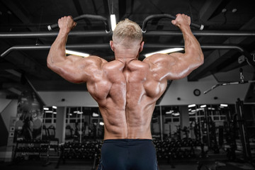  Brutal strong bodybuilder man pumping up muscles and train gym