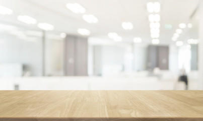 wood table top and blurred bokeh office interior space background - can used for display or montage 