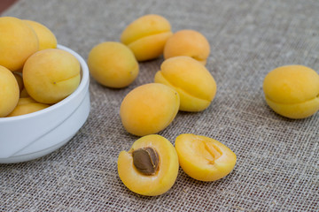 A few yellow apricots on the table. Summer fruits