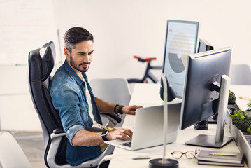 Poster - Serene bearded man working on laptop