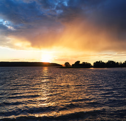 Wall Mural - sunset on the lake with trees on the shore