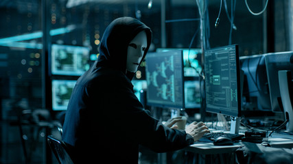 Aufkleber - Masked Hacktivist Organizes Massive Data Breach Attack on Corporate Servers. He is in Underground Secret Location Surrounded by Displays and Cables.