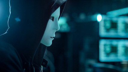 Aufkleber - Close-up Shot of Masked Hacktivist Organizes malware Attack on Global Scale. He's in Underground Secret Location Surrounded by Displays and Cables.