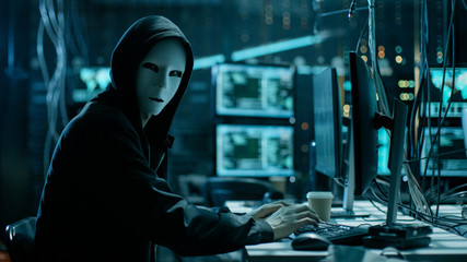Aufkleber - Masked Hacker is Using Computer for Organizing Massive Data Breach Attack on Corporate Servers. They're in Underground Secret Location Surrounded by Displays and Cables.