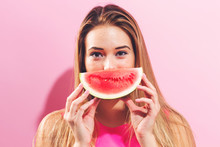 Happy Young Woman Holding Watermelon On A Pink Background