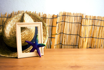 Wall Mural - hat with frame and starfish on table wood in summer concept