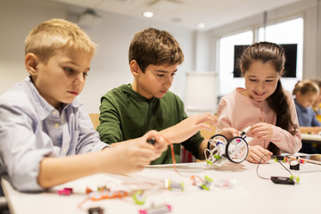 Wall Mural - happy children building robots at robotics school