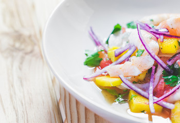 Refreshing dish of fish marinated in citrus juice. Shrimp and Mango Ceviche. Diet and healthy food concept