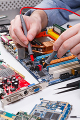 Poster - Engineer checking motherboard with multimeter