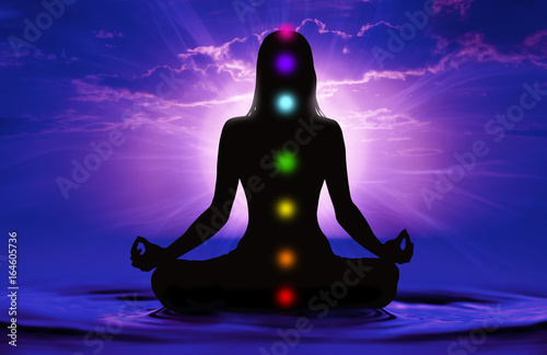 Silhouette of woman doing yoga and where has scored seven chakra points Wallpaper Mural