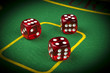 © Aleksei - risk concept - playing dice on a green gaming table. Playing a game with dice. Red casino dice rolls. Rolling the dice concept for business risk, chance, good luck or gambling
