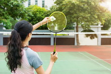 Girl Serving On A Badminton Match Outdoors