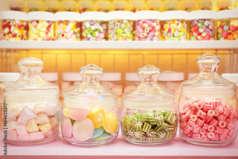 Different sweets in jars at candy shop
