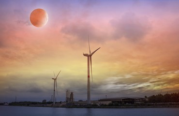 Full moon background .Wind Turbines  . Cityscape Sunset . eclipse of the moon . Natural resources