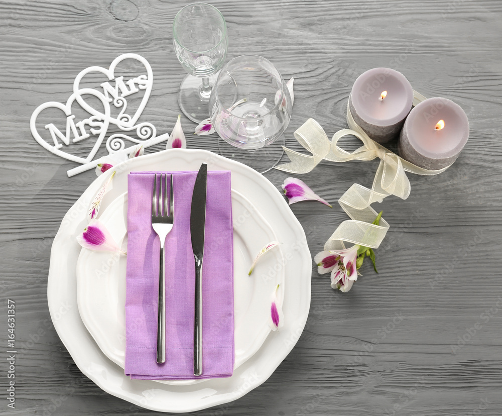 Beautiful table setting for lesbian wedding on wooden background