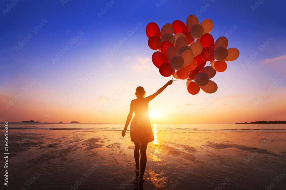 inspiration, joy and happiness concept, silhouette of woman with many flying balloons on the beach - obrazy, fototapety, plakaty 