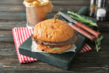 Wall Mural - Tasty homemade burger on wooden table